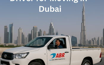 A pickup truck with driver ready for moving service in Dubai, branded with ABR Transport.